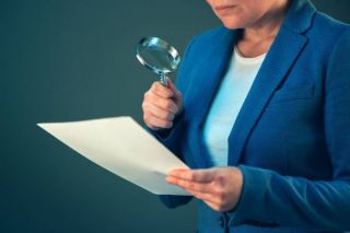 depositphotos 134222838 stock photo female tax inspector looking at